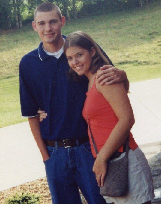 A young man and woman pose for the camera
